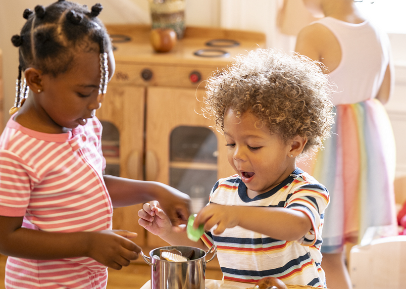 Two children playing together inside.