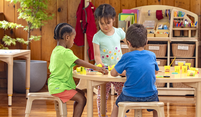 Three children doing an activity at a table