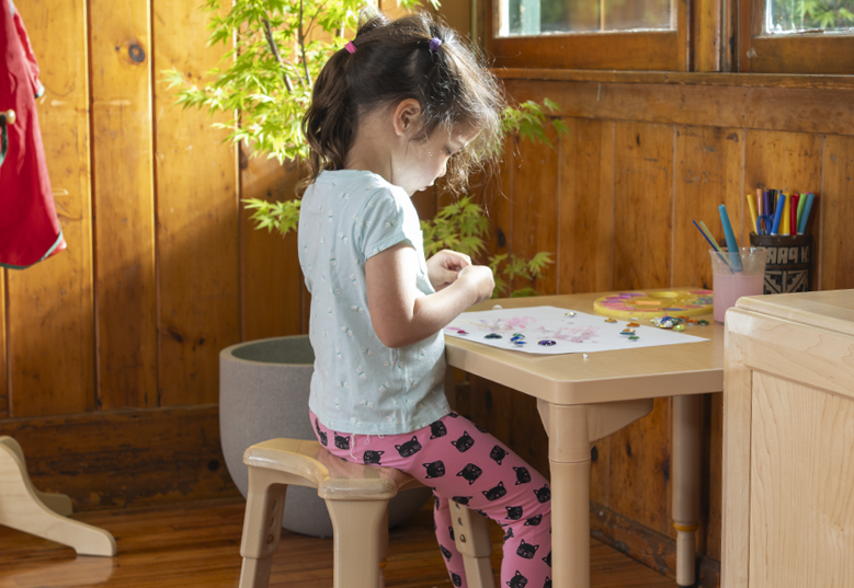 A child doing an activity at a table