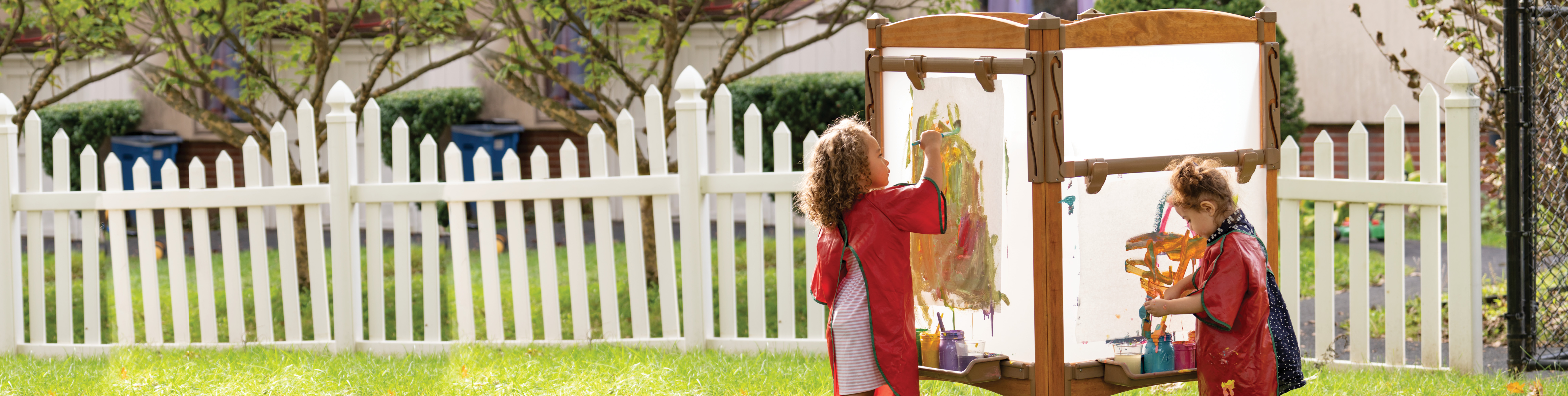 Two children painting on an Outlast Easel