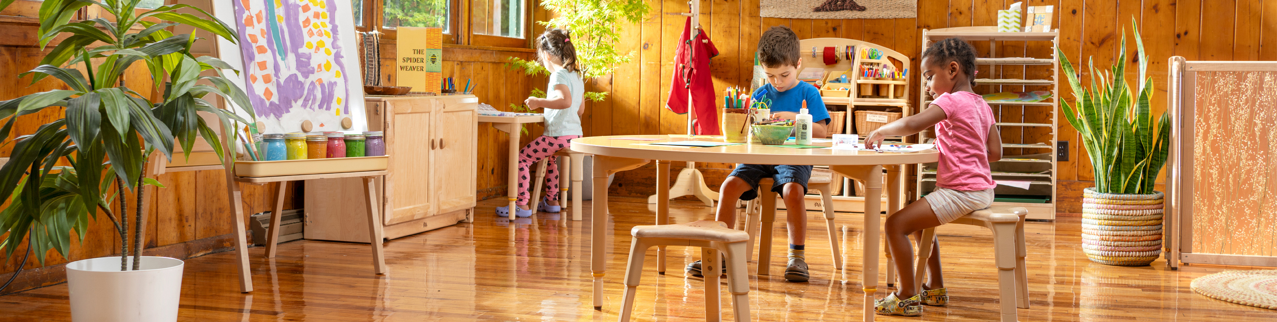 Children Sitting on Grow Right stools doing art projects at tables