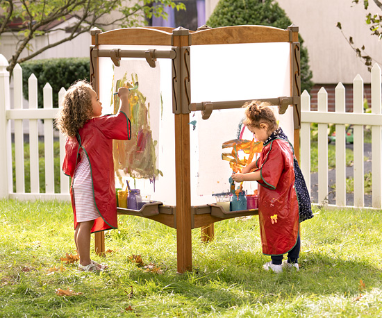 Kids painting at outdoor easel